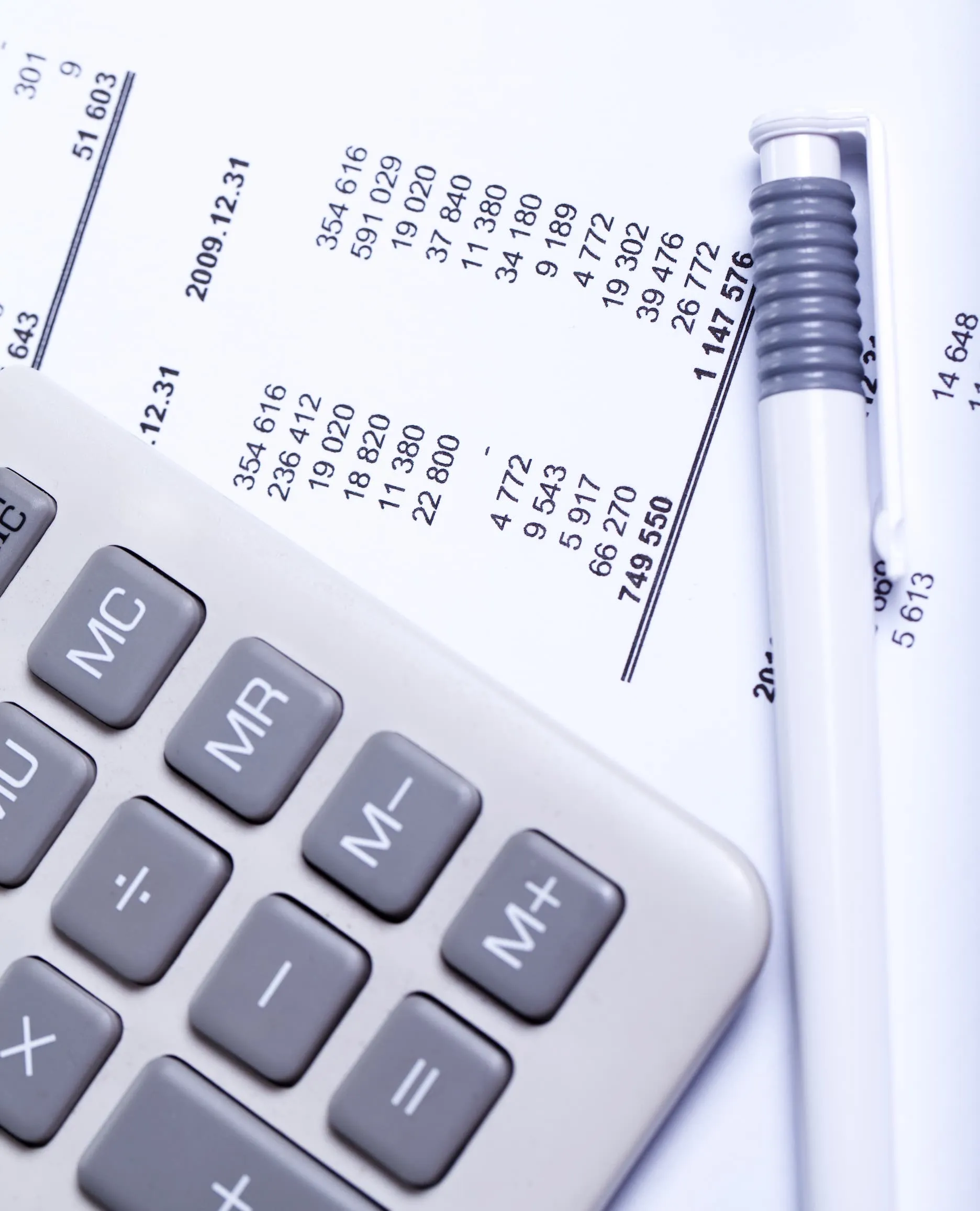 Imagen de una calculadora y unas hojas impresas de material contable.